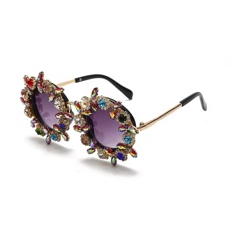 The Vision Junkie Tiny sunglasses with oversized purple lenses and colorful gemstone embellishments